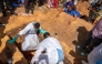 A woman (top R) reacts as a person suspected of having died from Ebola is buried in Bunia, in the eastern Democratic Republic of the Congo, on May 25, 2026. (Photo by Glody MURHABAZI / AFP)
