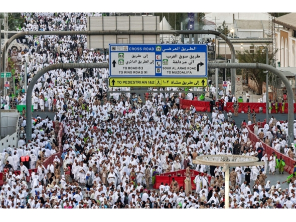 Muslim pilgrims pray near Saudi Arabia's Mount Arafat during the climax of the Hajj pilgrimage early on May 26, 2026.  (Photo by Zain Jaafar / AFP)