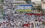 Muslim pilgrims pray near Saudi Arabia's Mount Arafat during the climax of the Hajj pilgrimage early on May 26, 2026.  (Photo by Zain Jaafar / AFP)