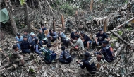 This handout image released by Metta Tham Rescue Kalasin on May 26, 2026, shows rescue workers gathering near a cave in Xaisomboun province. (Photo by Handout / Metta Tham Rescue Kalasin / AFP) 