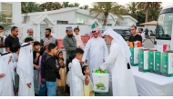 Ministry of Awqaf and Islamic Affairs representatives distributing gifts to children as part of the ‘Joy of Eid’ initiative.