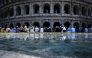 People sit in the shade of the Colosseum during an early-season heatwave in Rome on May 28, 2026. Photo by TIZIANA FABI / AFP