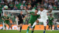 Ireland’s Troy Parrott (left) battles for the ball with Qatar’s Pedro Miguel. (AFP)
