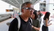 Ronson Chan, a journalist and former chairman of the Hong Kong Journalists Association, wearing a black shirt that reads 