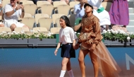 Japan's Naomi Osaka walks on court with a mascot for her women's singles match at the Roland-Garros Complex in Paris on May 30, 2026. (Photo by Thomas Samson / AFP)
