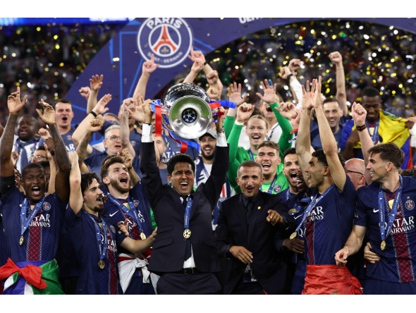 Paris Saint Germain's president Nasser al-Khelaifi (C) lifts the trophy as he celebrates with his players winning the UEFA Champions League final football match between Paris Saint-Germain (PSG) and Arsenal FC at the Puskas Arena in Budapest on May 30, 2026. (Photo by FRANCK FIFE / AFP)