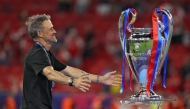 Paris Saint-Germain's Spanish head coach Luis Enrique walks to hug the trophy after winning the UEFA Champions League final football match between Paris Saint-Germain (PSG) and Arsenal FC at the Puskas Arena in Budapest on May 30, 2026. (Photo by Odd Andersen / AFP)