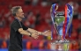 Paris Saint-Germain's Spanish head coach Luis Enrique walks to hug the trophy after winning the UEFA Champions League final football match between Paris Saint-Germain (PSG) and Arsenal FC at the Puskas Arena in Budapest on May 30, 2026. (Photo by Odd Andersen / AFP)