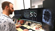 In this photo taken on May 5, 2026, chief scientific and operations officer Brett Kagan looks at cortical and hippocampal cells on cell culture plates in Melbourne. (Photo by William West / AFP) 