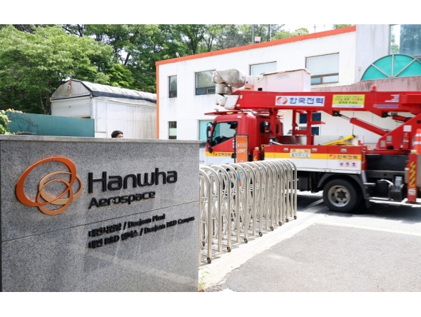A vehicle of Korea Electric Power Corporation enters the main gate at the Hanwha Aerospace plant in Daejeon on June 1, 2026, after a reported explosion. (Photo by Yonhap / AFP) 