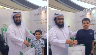 A child receives an Eid gift during the programme.  