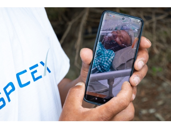Karma Gyaljen, a relative of mountaineer Dawa Sherpa, shows a photograph of Dawa Sherpa undergoing treatment in the intensive care unit (ICU) at HAMS Hospital in Kathmandu on June 5, 2026. (Photo by Prabin Ranabhat / AFP)