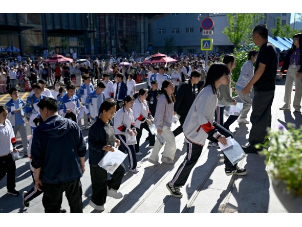 Students enter a school on the first day of China's National College Entrance Examination (NCEE) known as 