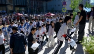 Students enter a school on the first day of China's National College Entrance Examination (NCEE) known as 