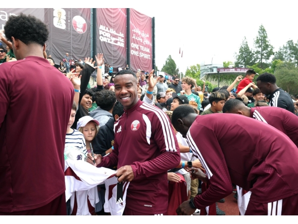 Qatar midfielder Assim Madibo signs autographs for young fans in Santa Barbara, California, on Friday. 