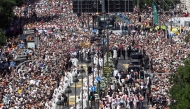 The crowd packs Alcala street as Pope Leo XIV walks under a processional canopy in Madrid on June 7, 2026. (Photo by Pierre-Philippe Marcou / AFP)