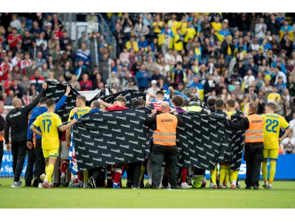 Denmark's and Ukraine's players huddle to accompany Christian Eriksen to a waiting ambulance during the football international friendly match between Denmark and Ukraine at Odense Stadium in Denmark, on June 7, 2026. (Photo by Bo Amstrup / Ritzau Scanpix / AFP)