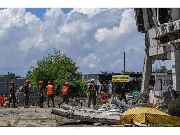 Responders conduct search and rescue operations at the site of a collapsed building after a 7.8 magnitude earthquake in General Santos City on June 9, 2026. (Photo by Jam STA ROSA / AFP)