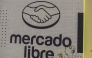 Mercado Libre is displayed on an advertising wall in Mexico City on October 1, 2025. (Photo by Yuri CORTEZ / AFP)
