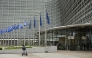 A woman rides an electric scooter past the Berlaymont building, the EU Commission headquarters, in Brussels on June 9, 2026. (Photo by Nicolas Tucat / AFP)
