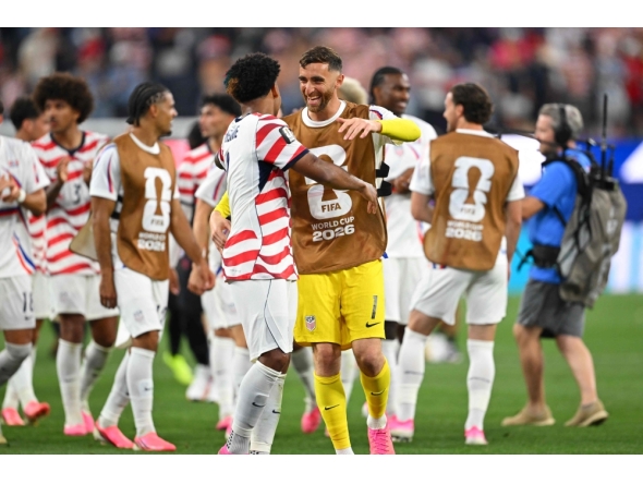 US goalkeeper #01 Matt Turner (R) and midfielder #08 Weston McKennie celebrate on June 12, 2026. (Photo by Patrick T. Fallon / AFP)
 