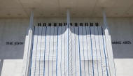 Tarps are hung on scaffolding outside The Kennedy Center on June 13, 2026 in Washington, DC. Friday late night workers removed the President Donald Trump's name from the Kennedy Center. (Photo by Tasos Katopodis/AFP)