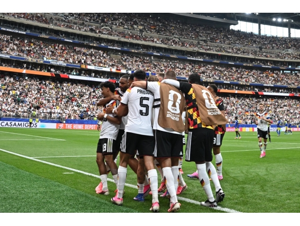 Germany's defender #18 Nathaniel Brown (C) celebrates with teammates after scoring his team's fifth goal during the 2026 World Cup Group E football match between Germany and Curacao at the Houston Stadium in Houston on June 14, 2026.
(Photo by RONALDO SCHEMIDT / AFP)