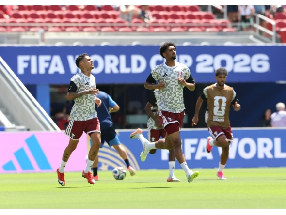 Qatar's Edmilson Junior (left), Homam Al Amin (centre) and Jassim Jaber warm up ahead of match against Switzerland.