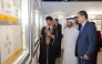 General Manager of Katara Cultural Village Foundation Professor Dr. Khalid bin Ibrahim Al-Sulaiti, Ambassador of the Republic of Tunisia to the State of Qatar H E Farhad Khalif and other officials view the gallery as artist Youssef Ftouhi explains his collection.