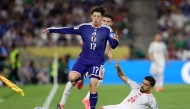 Tunisia's defender #21 Mohamed Ben Hamida kicks the ball out of the sidelines as Japan's forward #17 Yuito Suzuki jumps during the 2026 World Cup Group F football match between Tunisia and Japan at the Monterrey Stadium in Guadalupe, Mexico, on June 20, 2026. (Photo by Julio Cesar Aguilar / AFP)