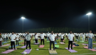 Ambassador of India to Qatar H E Vipul with other participants practising yoga.