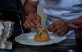 Congolese chef Archi Dimosi plates one of his signature dishes in Kinshasa on May 17, 2026. (Photo by Hardy Bope / AFP)