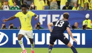 Brazil's forward #07 Vinicius Junior and Scotland's defender #13 Jack Hendry fight for the ball on June 24, 2026. (Photo by Patricia De Melo Moreira / AFP)