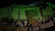 Rescue workers search through the rubble of a collapsed building in the Altamira neighbourhood following an earthquake in Caracas on June 24, 2026. (Photo by Federico ParraARRA / AFP)