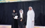 Minister of Education and Higher Education H E Lolwah bint Rashid bin Mohammed Al Khater honouring a graduate of Qatar School for Science and Technology for Boys during a ceremony.