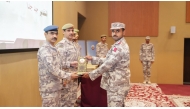 Senior military officials present an award to a graduate.