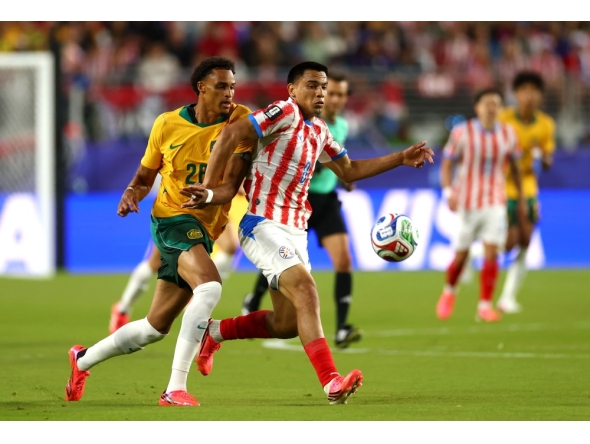 Tete Yengi #26 of Australia competes for the ball against Diego Gomez #8 of Paraguay. Dean Mouhtaropoulos/Getty Images/AFP