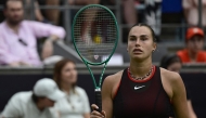 Belarus' Aryna Sabalenka walks back on the tennis court after picking up a new racket from the side as she plays against Jessica Pegula of the US during their women's singles semi-final match at the WTA500 Berlin Tennis Open tournament in Berlin on June 20, 2026. (Photo by John MACDOUGALL / AFP)