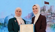Head of the Family Affairs Section at the Ministry of Social Development and Family Sheikha Ali Al Marri receives a certificate during the event.