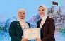 Head of the Family Affairs Section at the Ministry of Social Development and Family Sheikha Ali Al Marri receives a certificate during the event.