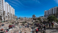 A rescue dog from the Argentine search and rescue team searches for bodies in the rubble of a collapsed building in Caraballeda, La Guaira state, Venezuela, on June 28, 2026, following twin earthquakes. (Photo by Miguel Medina / Pool / AFP)