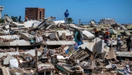 Volunteers and residents search for survivors on the rubble of collapsed buildings in Caraballeda, La Guaira state, Venezuela, on June 28, 2026, following earthquakes. Photo by Miguel MEDINA / POOL / AFP