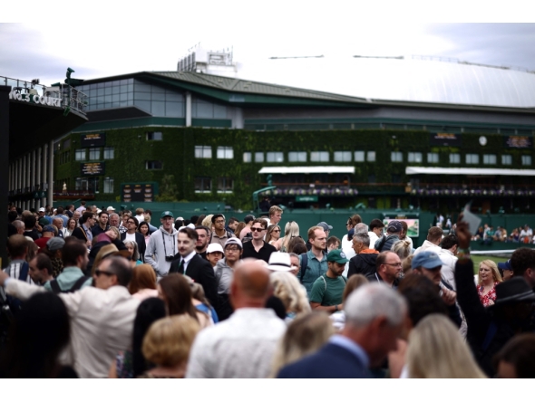 People await the start of the matches on the second day of the 2026 Wimbledon Championships at The All England Lawn Tennis and Croquet Club in Wimbledon, southwest London, on June 30, 2026. (Photo by Henry Nicholls / AFP) 