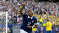 Kylian Mbappe #10 of France celebrates scoring his team's third goal. Al Bello/Getty Images/AFP