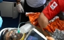 An international rescue team assists a survivor of Venezuela's twin earthquakes in Catia La Mar, La Guaira State, Venezuela on July 2, 2026, eight days after the quake. Hernan Gil, a 43-year-old security guard, had been buried in the booth of the seven-story building where he worked in Catia La Mar, a coastal area in the state of La Guaira devastated by the disaster. (Photo by Federico PARRA / AFP)
 