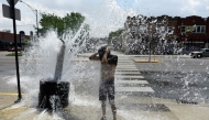 A person cools off with water from an open fire hydrant during a heat wave on the West Side of Chicago, Illinois, on July 2, 2026. (Photo by Octavio Jones / AFP)