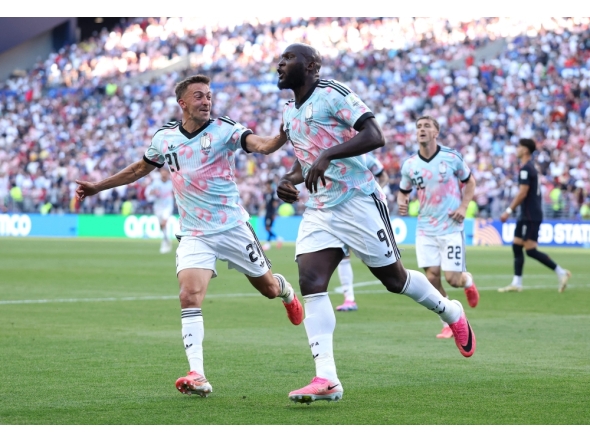 Romelu Lukaku #9 of Belgium celebrates with Timothy Castagne #21 after scoring the team's fourth goal. Jamie Squire/Getty Images/AFP