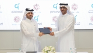 Executive Director of QCDC Saad Abdulla Al-Kharji and Deputy Chief Executive Officer of QFSW Khalid bin Mohammed Al-Kuwari exchange documents after signing of the MoU.