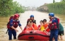 Rescue workers evacuate flood-affected students in Guigang, in China's southern Guangxi region, on July 8, 2026. (Photo by CN-STR / AFP)