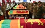 Security personnel pay tribute as they stand next to coffins of seven guards killed during Negombo prison riot in Colombo July 8, 2026. (Photo by Ishara S. Kodikara / AFP)